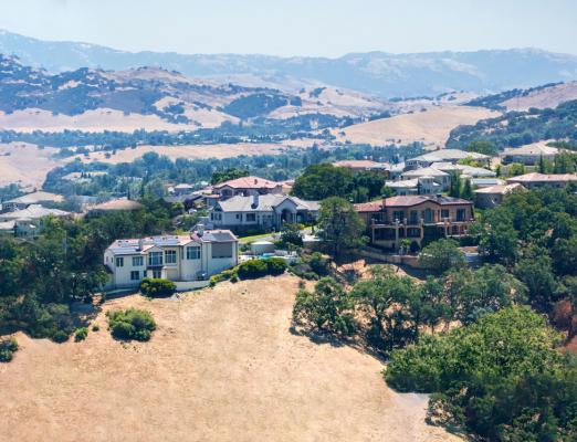 Luxury homes with mountain views in the background. 